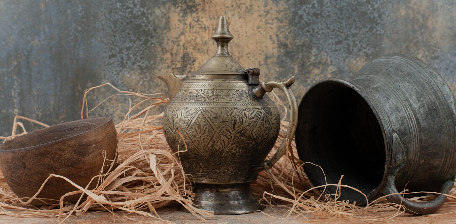 Traditional vessels and wooden tray photographed in a rustic still-life setting