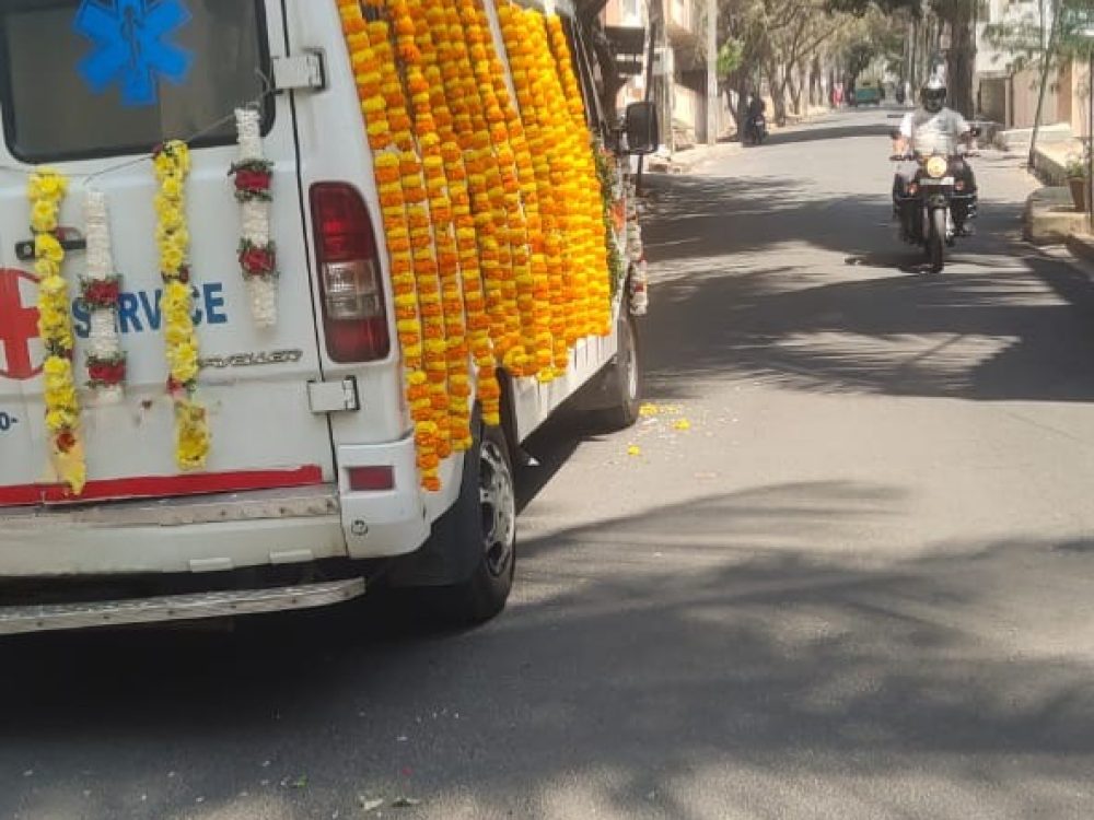 Hearse Van With simple floral arramgements for funeral services