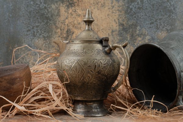 Two ancient kettles with empty wooden plate on burlap Funeral Services, Cremation Services, Cremation Urns